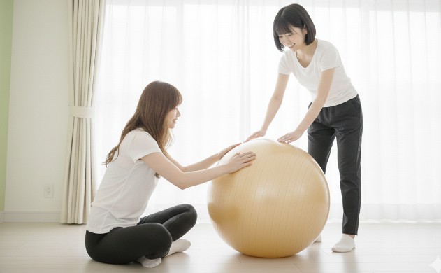 バランスボールの正しい選び方(安全設計)
シャンパンゴールドのバランスボールを中央に置き、
あいみがボールの表面を触って安全性を確認している。
美羽が横で頷きながら見守る。
柔らかい光で“安心・安全”を表現。